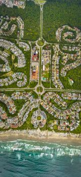 Stunning aerial view showcasing a coastal city's unique spiral road layout and lush greenery.