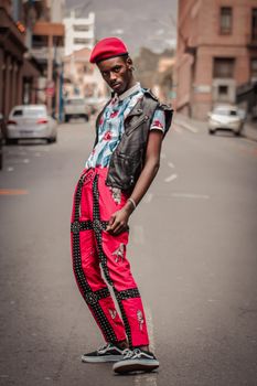 Stylish model poses in vibrant urban fashion on a Cape Town street.