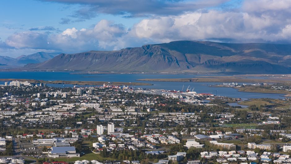 Stunning aerial view of Reykjavik with Esja Mountain in the backdrop during summer.