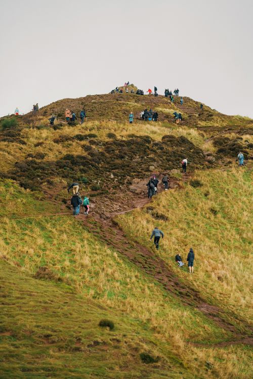 Free People hiking on Arthur's Seat, Edinburgh on a cloudy day. Stock Photo