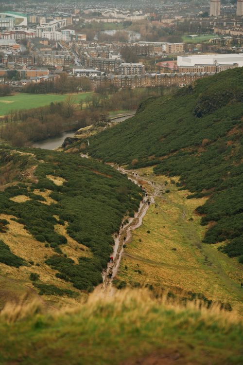 Free Aerial view of rolling green hills and the cityscape of Edinburgh, Scotland. Stock Photo