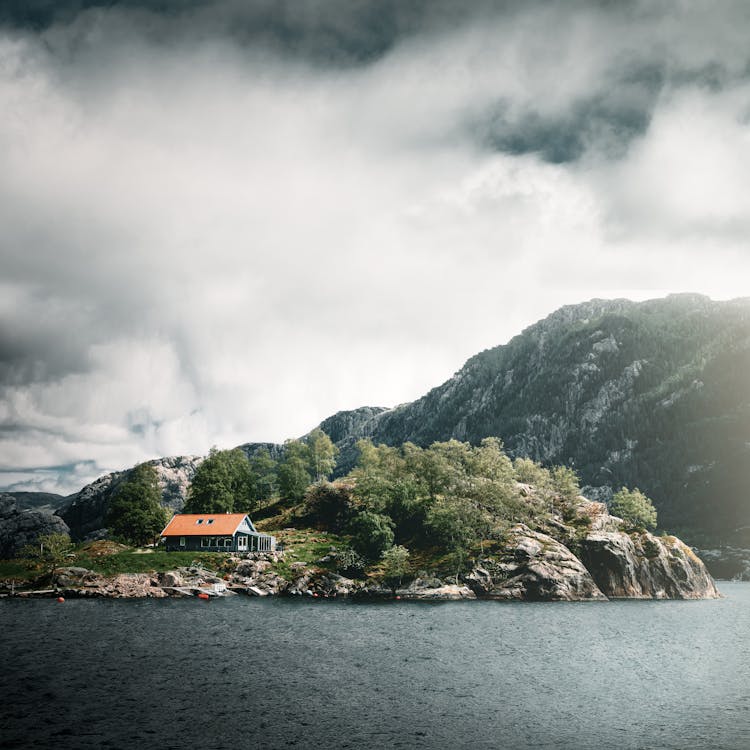 A House On An Island Surrounded By Trees