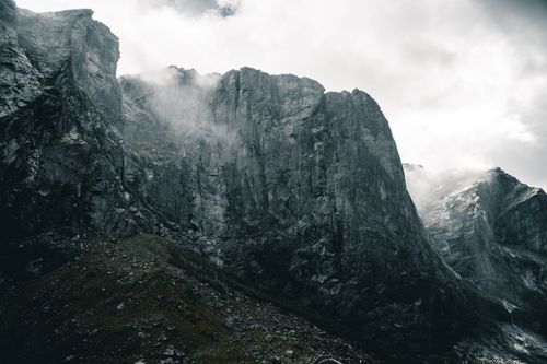 Free Stunning view of dramatic cliffs veiled in mist, Norway's rugged beauty captured in a serene moment. Stock Photo