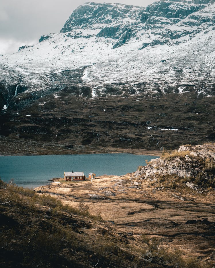 Cabin Beside Body Of Water Near Mountain