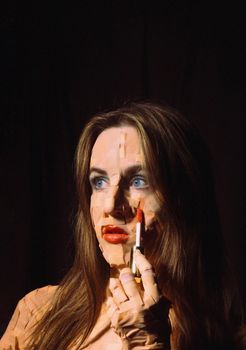 Surreal portrait of a woman with lipstick, featuring a fragmented visual effect creating a textured look.