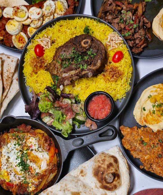 A delicious spread of Middle Eastern halal dishes including lamb and yellow rice