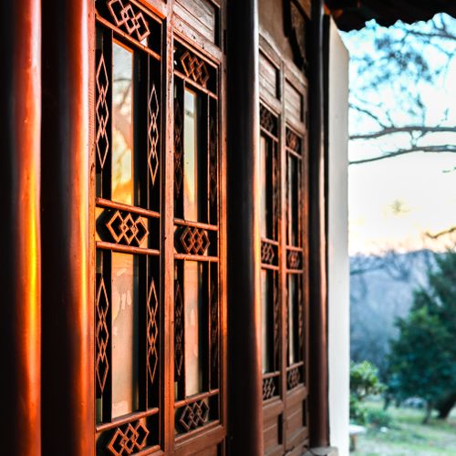 Free A captivating view of traditional Chinese wooden windows reflecting the sunrise, set in Nanjing, China. Stock Photo