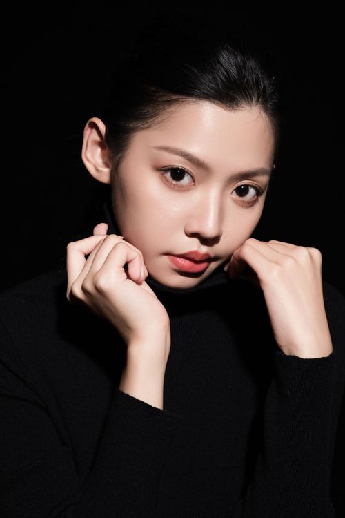 Free Stunning close-up portrait of a woman in black, highlighting elegance and style. Stock Photo
