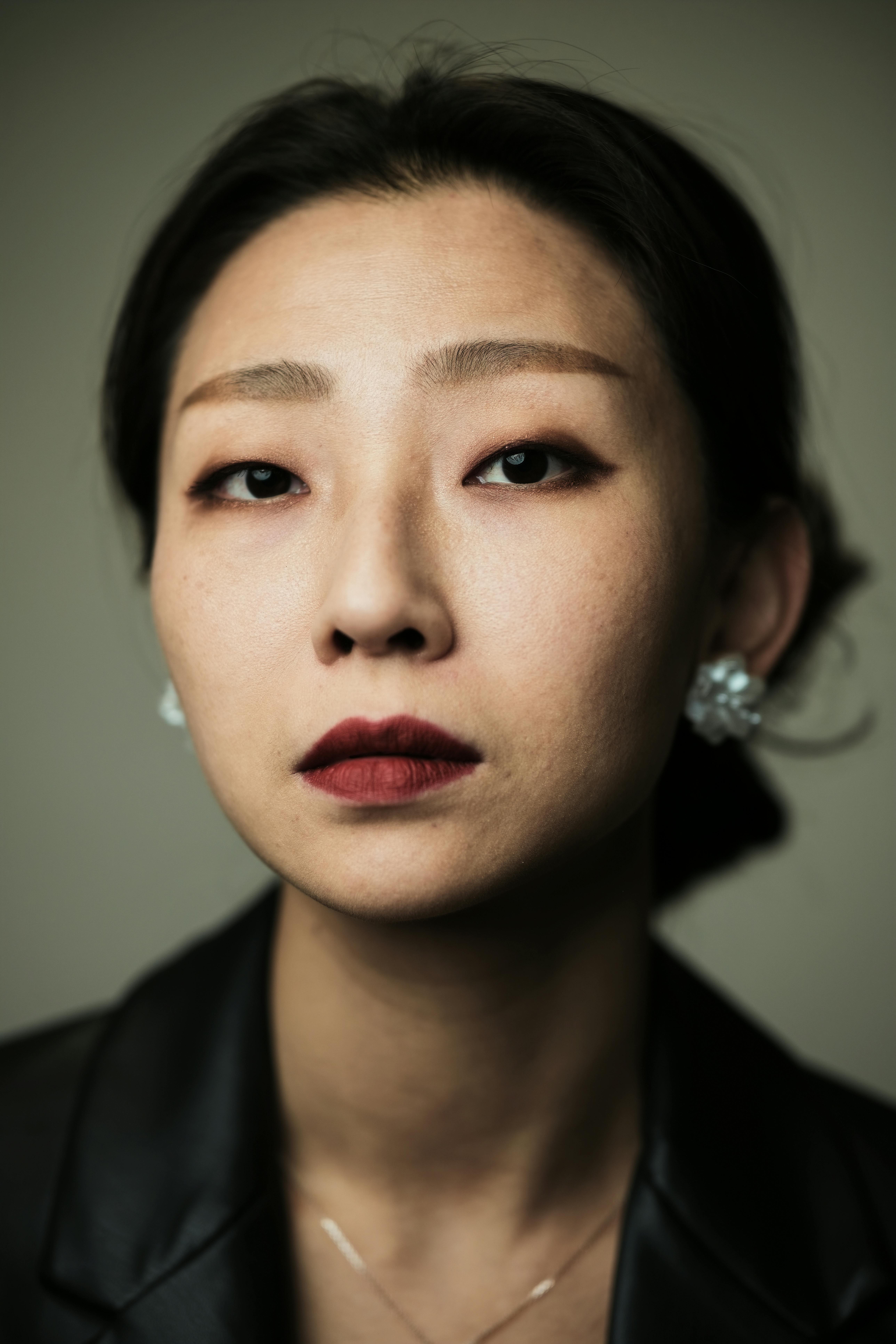 Stylish portrait of a woman in a black jacket with red lipstick. Elegance and confidence.