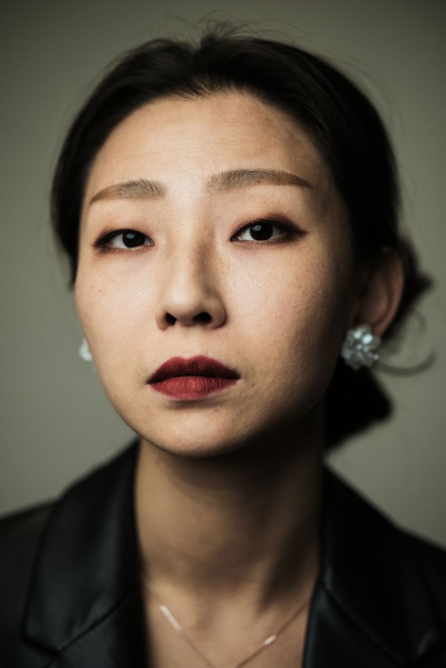 Stylish portrait of a woman in a black jacket with red lipstick. Elegance and confidence.