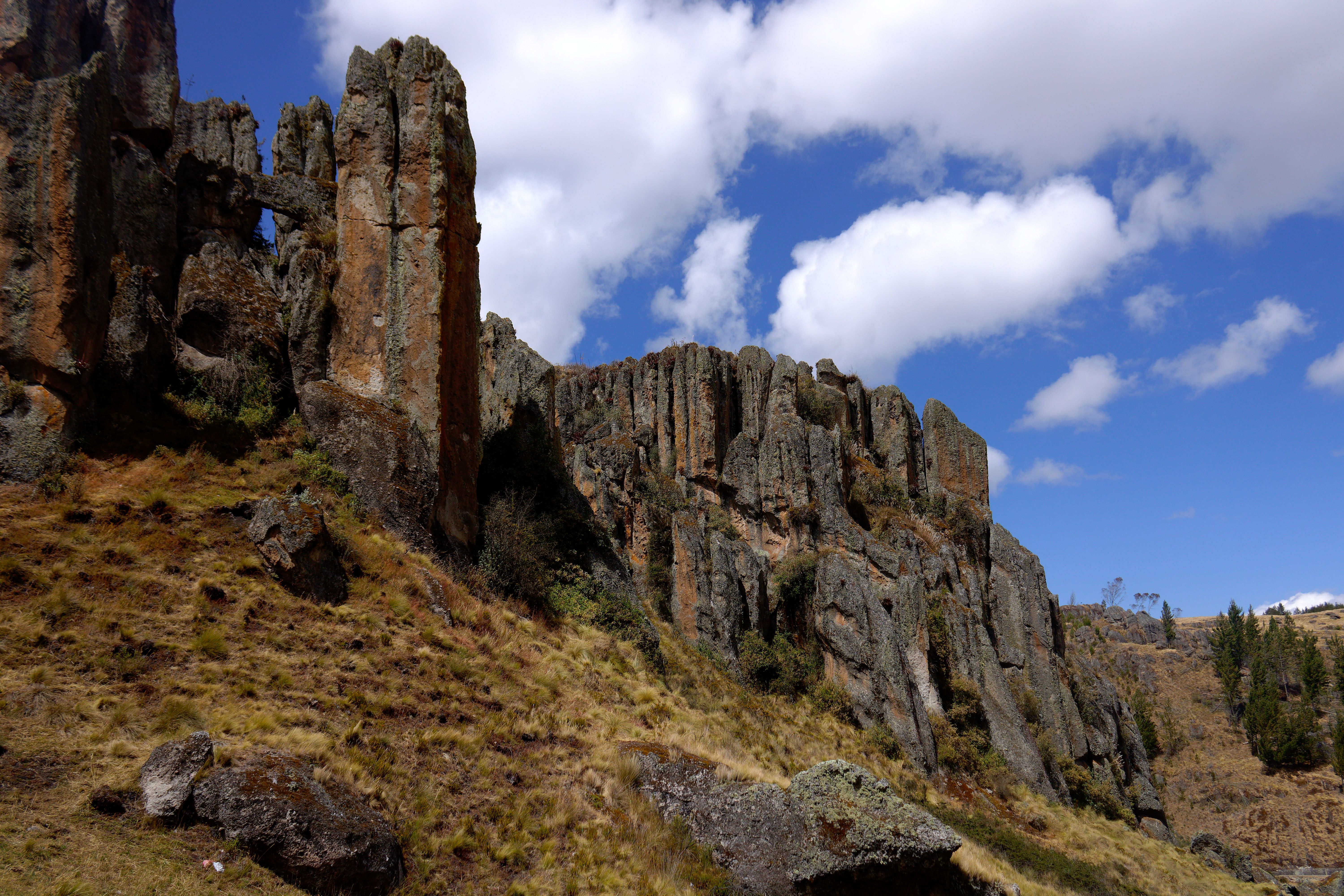 Capture of striking stone formations under a clear blue sky in Cajamarca, Peru.