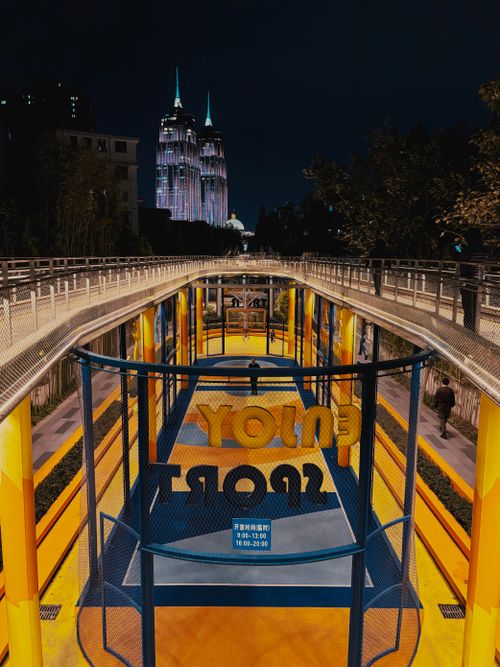 Free Vibrant night view of an outdoor basketball court in Shanghai with city skyline. Stock Photo