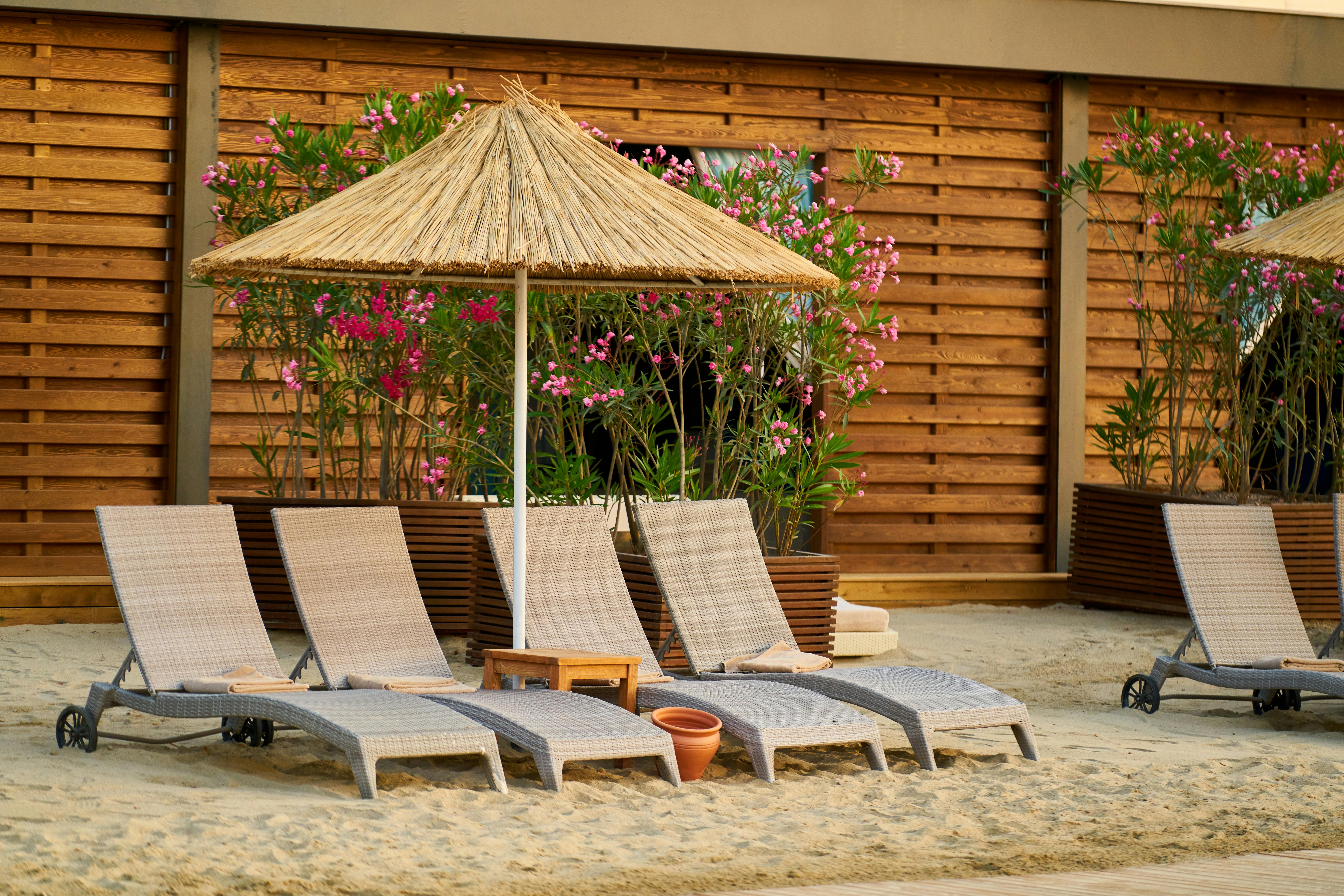 Wicker Outdoor Lounge Chairs On Sand · Free Stock Photo