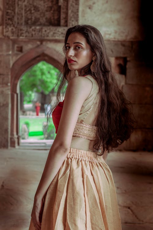 Free Standing Woman Wearing Sleeveless Dress Stock Photo