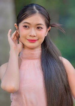 A serene portrait of a young Vietnamese woman wearing a traditional ao dai.