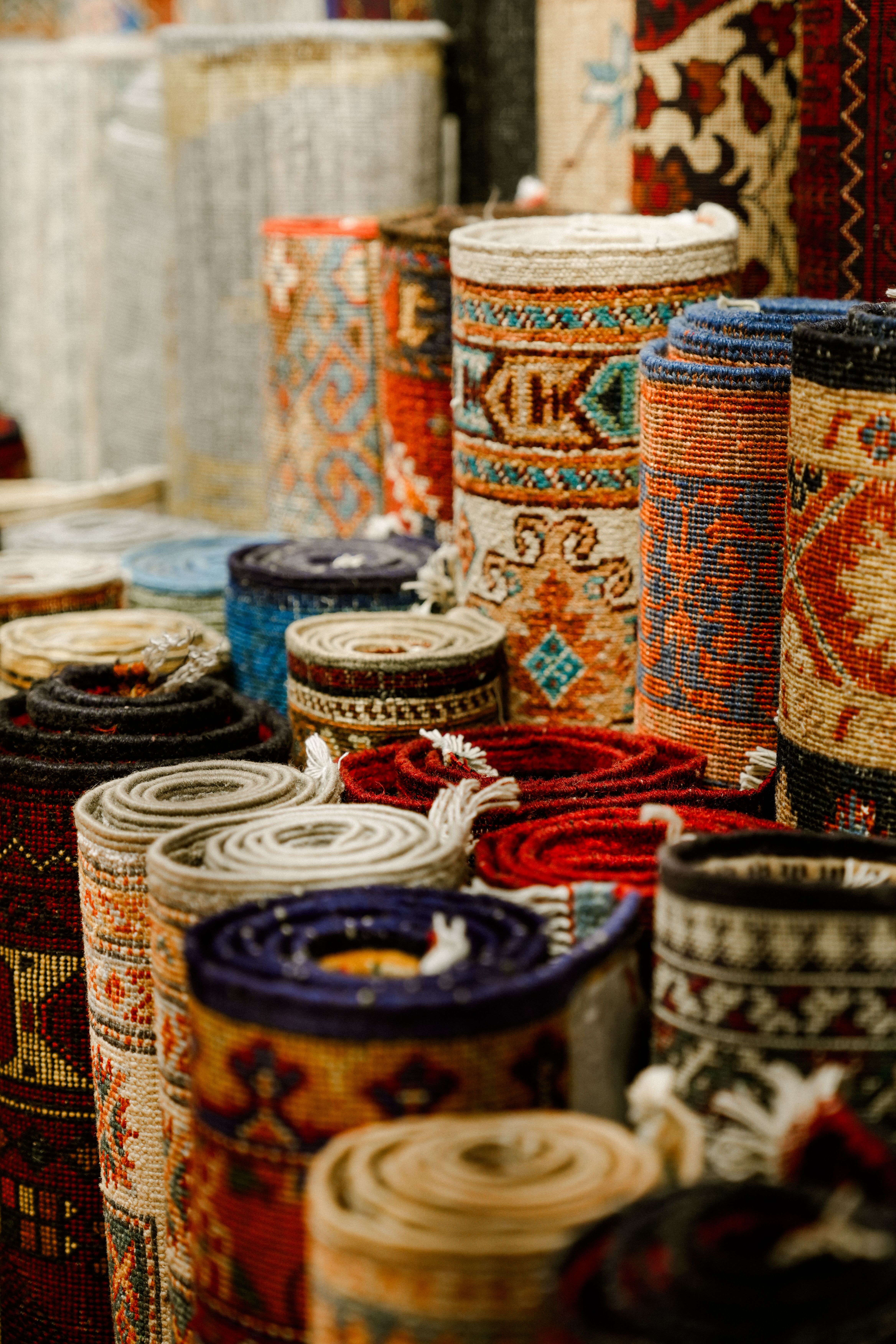 Colorful Rolled Oriental Rugs in Market Display · Free Stock Photo