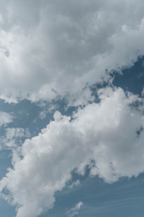 Free Serene white clouds floating in a clear blue sky during the day. Stock Photo