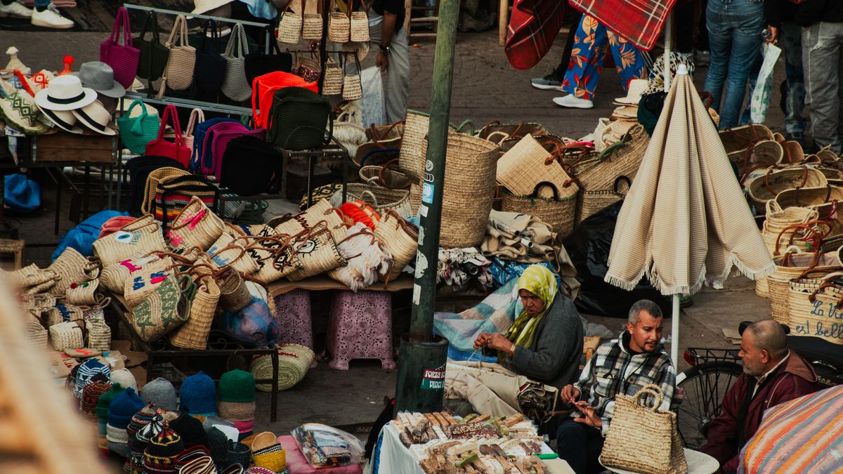 Colorful goods and textiles filling the stalls of a Marrakech souk