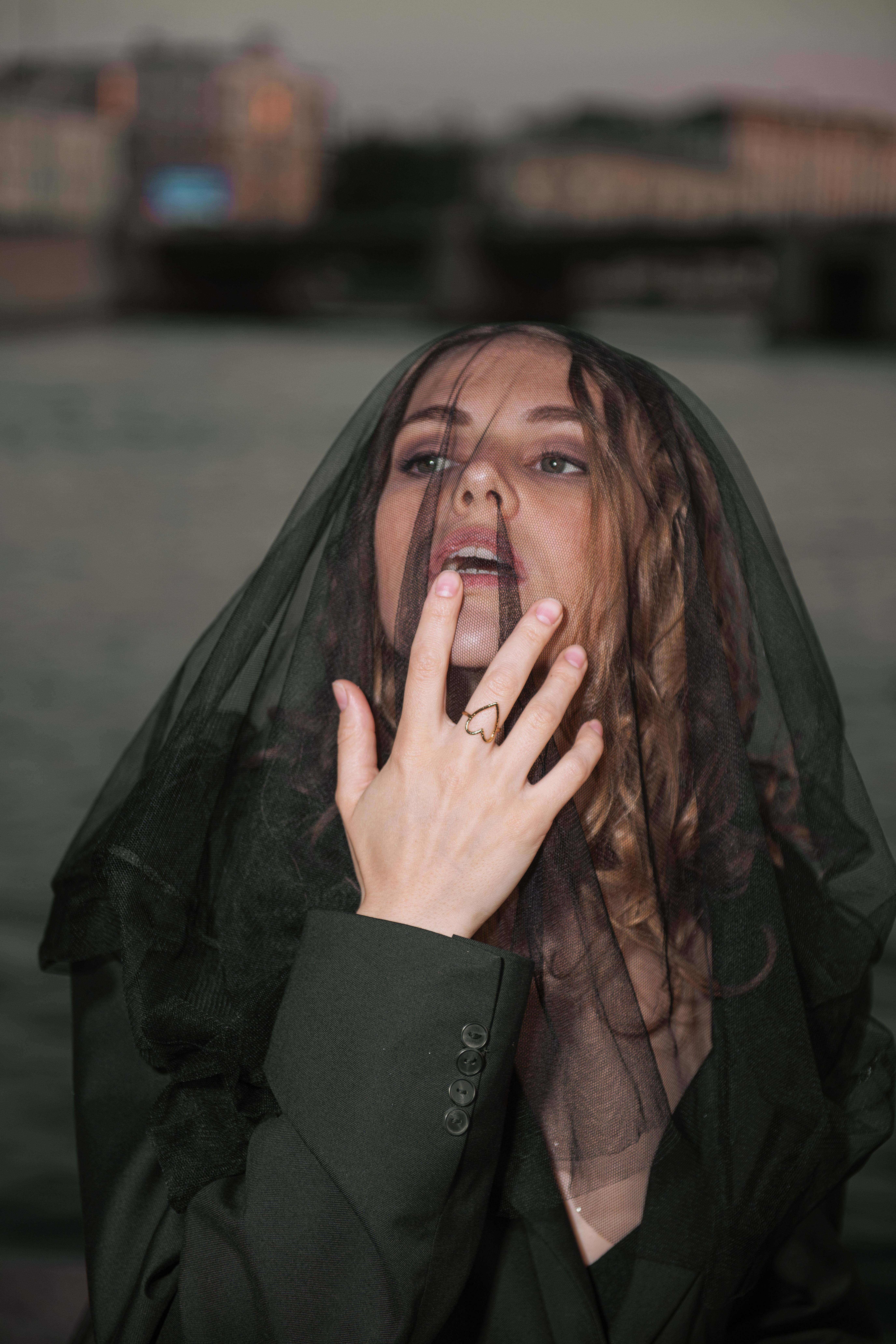 Portrait of Woman Draped in Black Veil Outdoors · Free Stock Photo