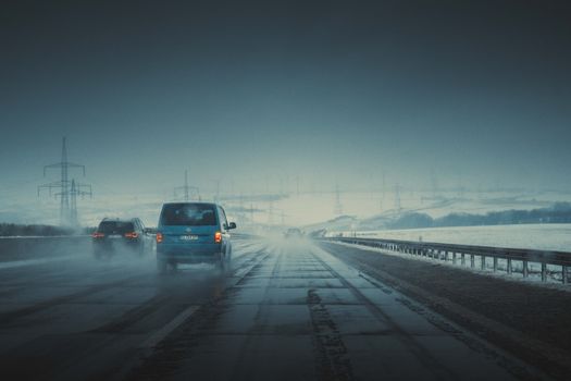 Vehicles on a misty highway at twilight, creating an atmospheric and cinematic scene.