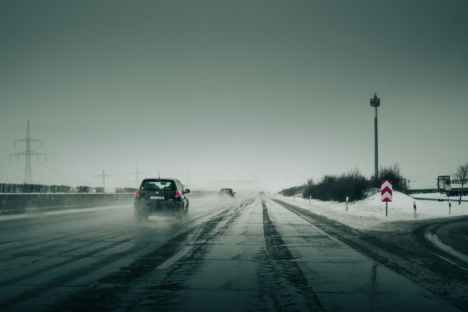 Car driving on a snowy highway