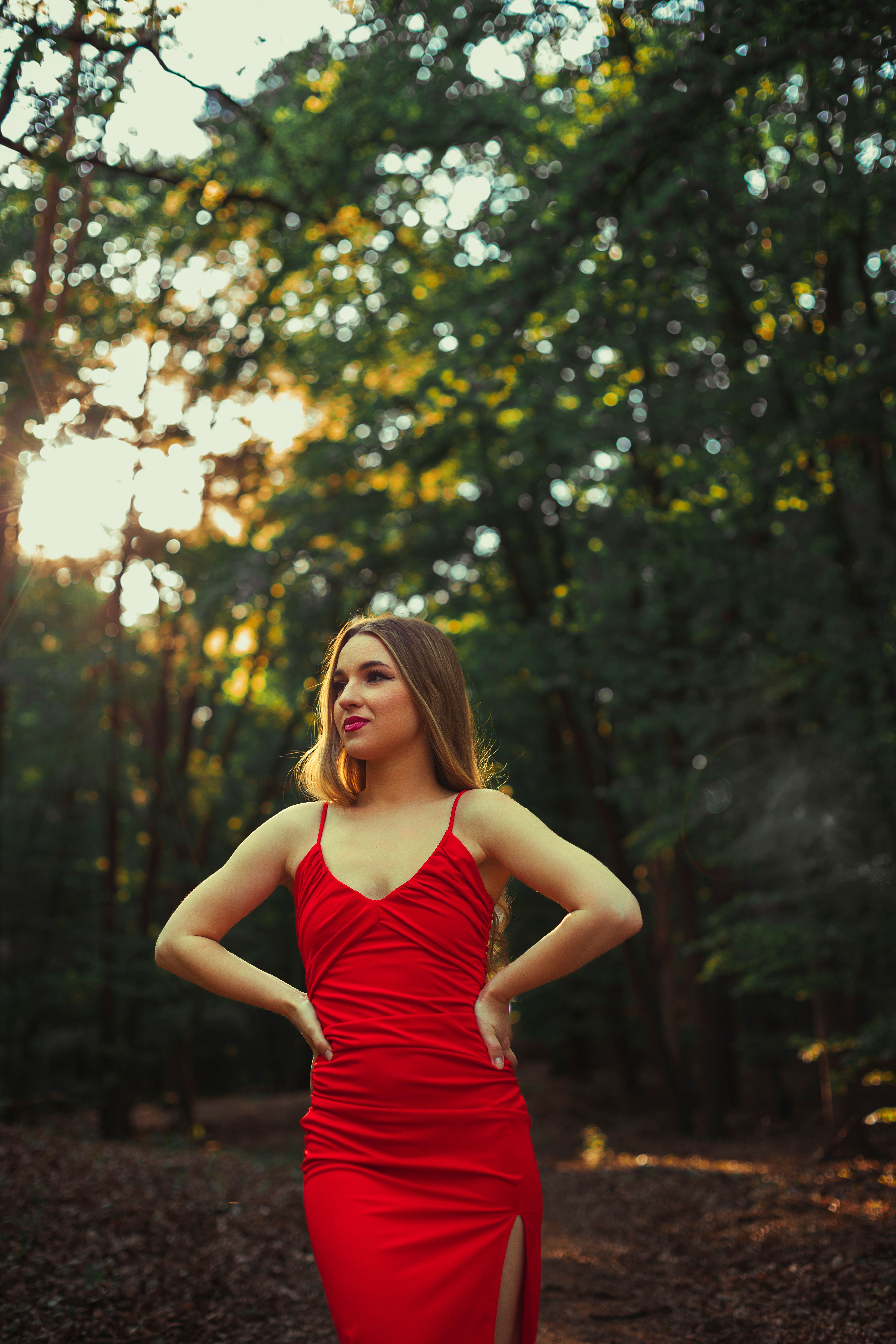 Elegant Woman in Red Dress Amidst Forest Scenery · Free Stock Photo