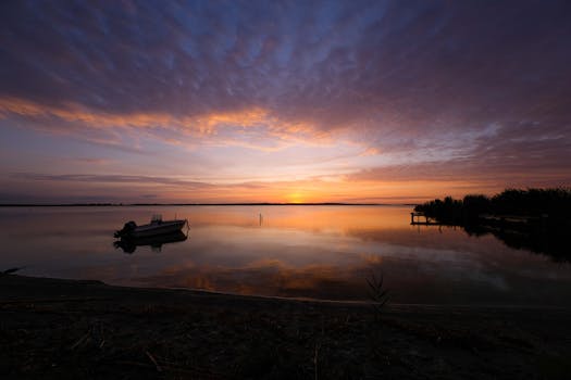 Serene sunset over calm water with reflections in Sardegna, Italy.