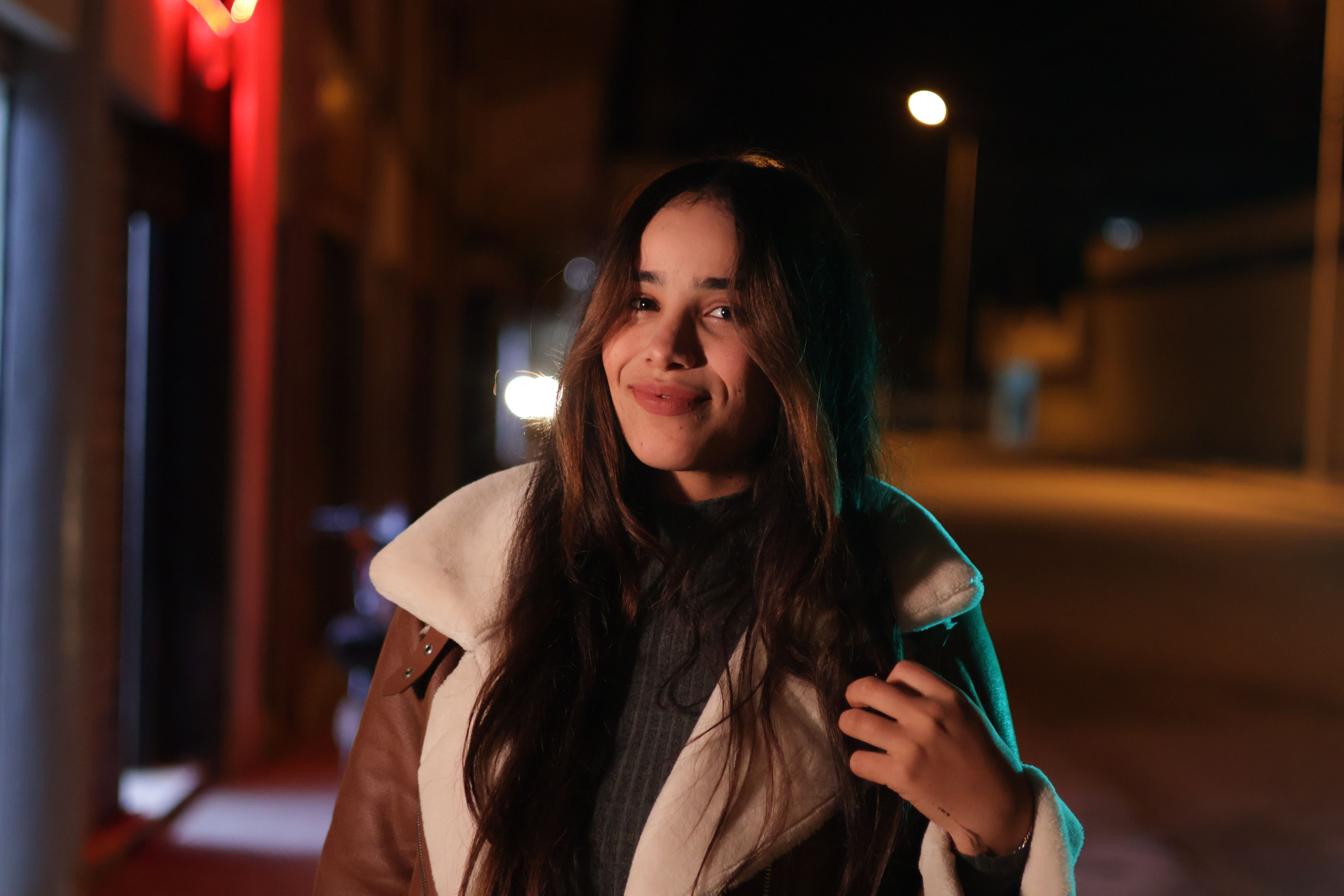 Young woman looking at phone with concerned expression