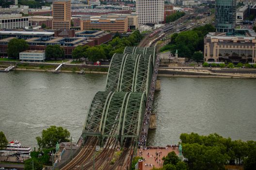 Aerial view showcasing the iconic Hohenzollern Bridge spanning the Rhine River in Cologne, Germany.