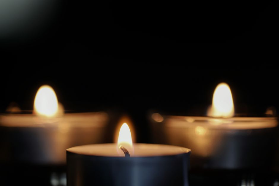 Flickering flameless LED tealight candles casting a cozy glow in an entryway, creating a warm and inviting atmosphere.