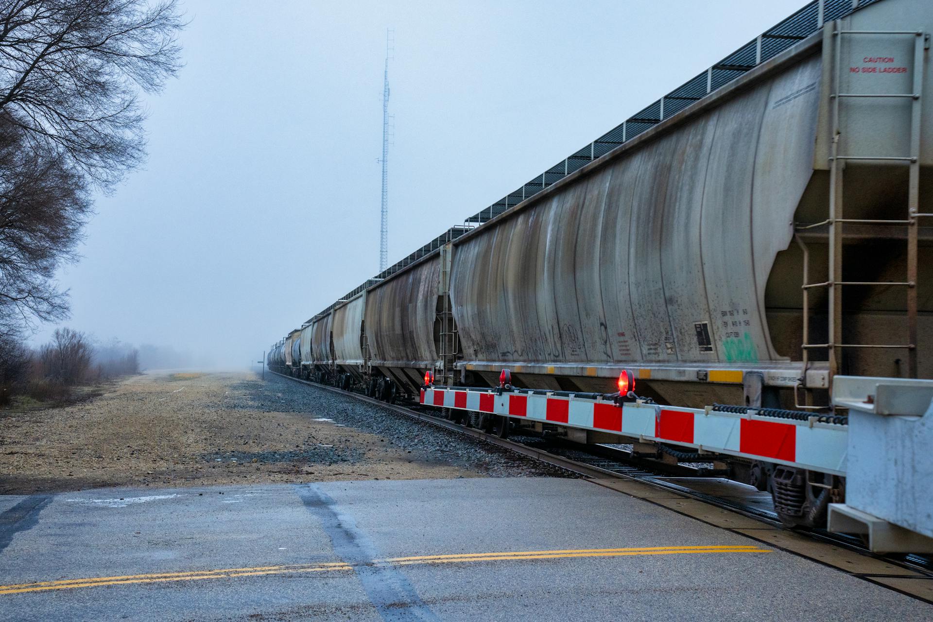 Freight train crossing in misty weather on a rural track in Wabasha, Minnesota.