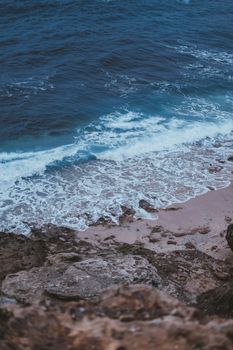 Captivating view of the Atlantic Ocean waves hitting the rocky cliffs in Rabat, Morocco.