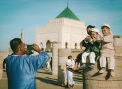 Children in traditional attire pose for a photo at Mohamed V Mausoleum in Rabat, Morocco.