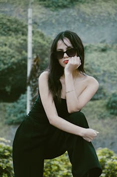 Fashionable woman in sunglasses posing in outdoor setting, Callao, Perú.