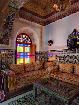 Colorful Moroccan interior featuring traditional decor and vibrant stained glass.