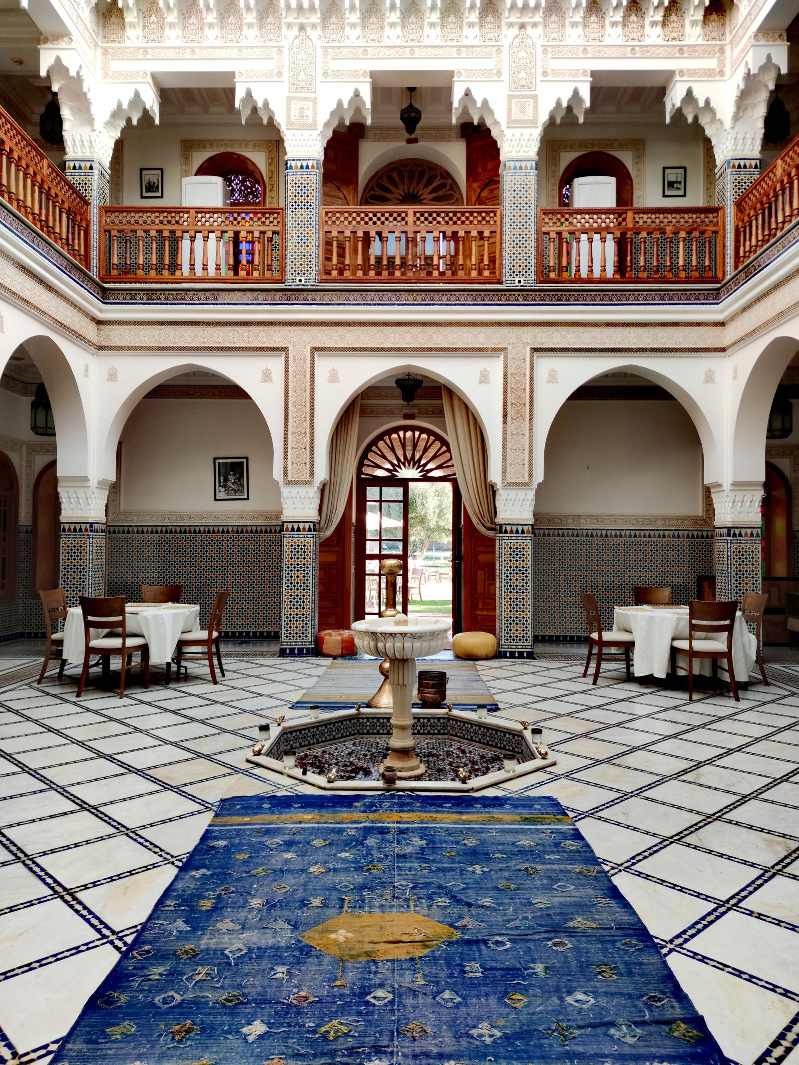 Traditional Moroccan riad courtyard with fountain and mosaic tiles