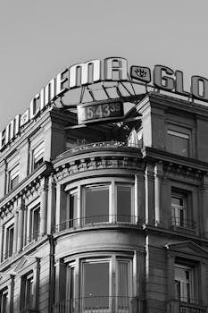 Monochrome image of a historic cinema building with a vintage architectural style.