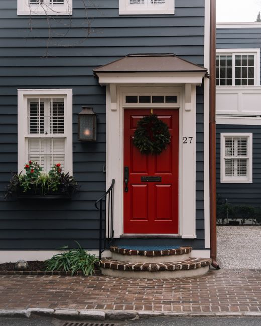 A charming Charleston house entry adorned with a festive Christmas wreath.