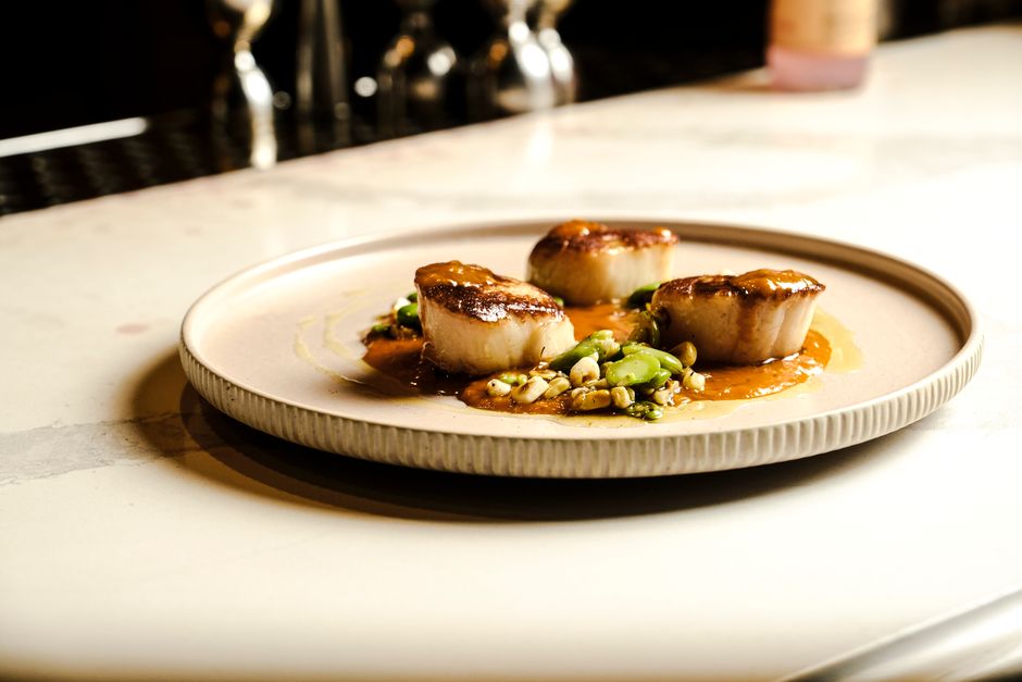 A gourmet plated meal featuring perfectly seared scallops, vibrant vegetables, and an artistic sauce drizzle, showcasing intricate details and fine dining presentation - awesome catering dfw A gourmet plated meal featuring perfectly seared scallops, vibrant vegetables, and an artistic sauce drizzle, showcasing intricate details and fine dining presentation - awesome catering dfw