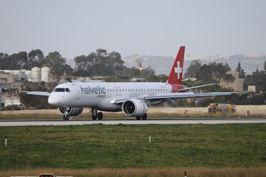 Helvetic Airways plane on the runway ready for takeoff, showcasing aviation technology.