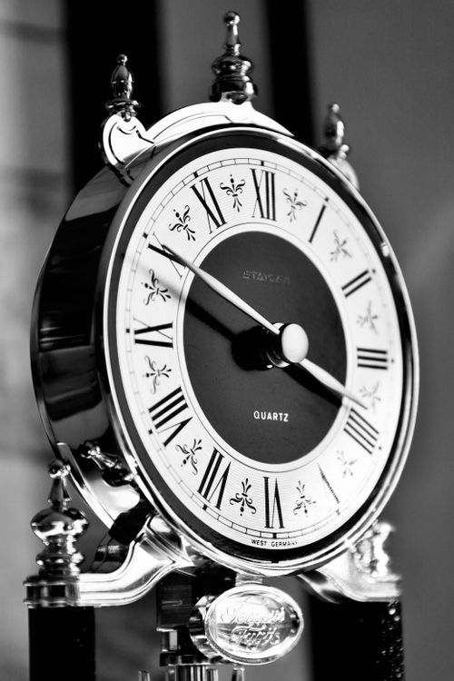 Free Close-up of a vintage style quartz clock with Roman numerals, capturing the essence of time. Stock Photo
