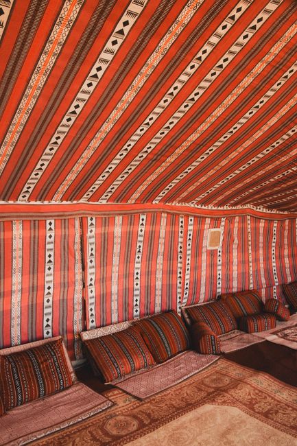 Explore the vibrant interior of a Bedouin tent in Bidiyah, Oman.