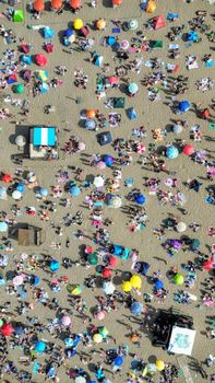 Vibrant aerial shot of a crowded beach with umbrellas and people in Argentina.