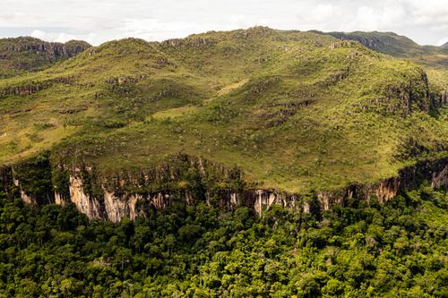 Free Stunning aerial view of lush mountains and dense forest under a cloudy sky. Stock Photo