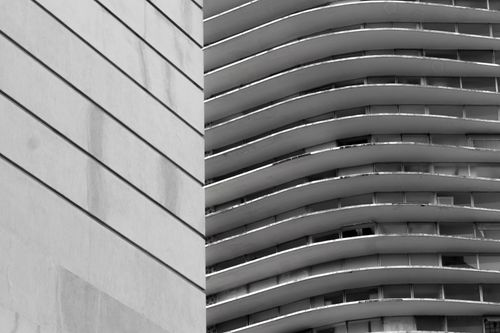 Free Explore the striking lines of a modern curved building facade captured in monochrome. Stock Photo