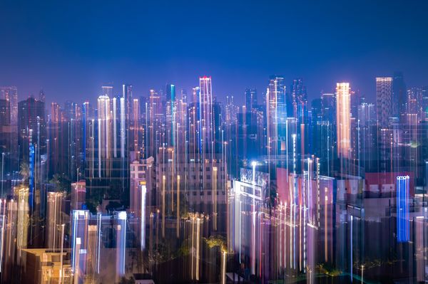 Uma captura dinâmica do horizonte de Jacarta à noite com faixas vibrantes de luzes neon e luzes da cidade.