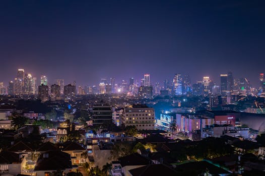 A stunning view of Jakarta's skyline at night, featuring brightly lit cityscapes and vibrant atmospheres.