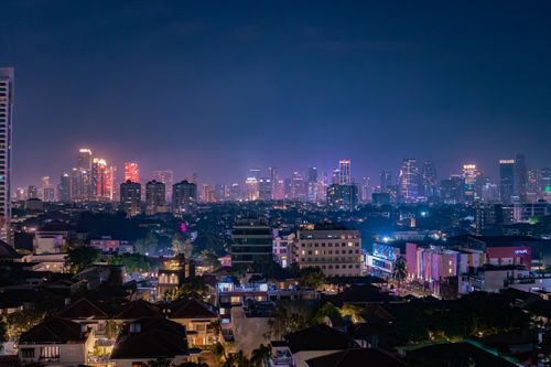Free A dazzling view of Jakarta's skyline at night with vibrant city lights and modern architecture. Stock Photo