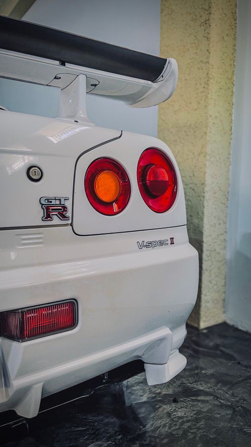 Free Detailed view of a white sports car's rear with iconic design and GT-R badge. Stock Photo
