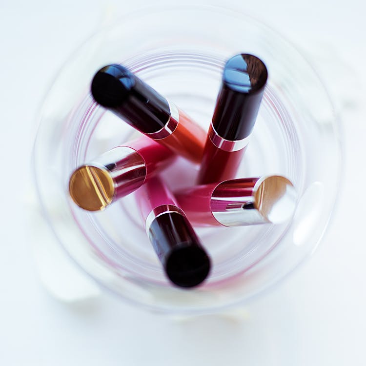 December Beauty trends Article Image Five Assorted-color Liquid Lipsticks Placed on Glass Stock Photo